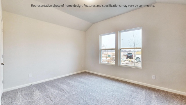 spare room with carpet and vaulted ceiling