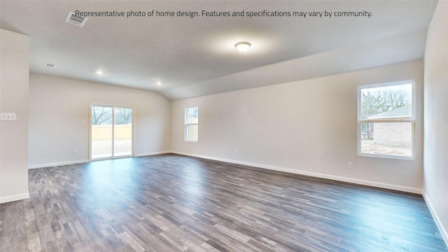 spare room with dark hardwood / wood-style floors and vaulted ceiling