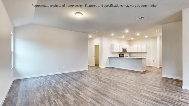 unfurnished living room featuring light hardwood / wood-style flooring and lofted ceiling