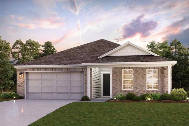 view of front of house with a garage and a lawn