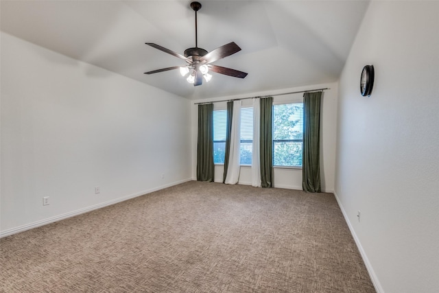 carpeted empty room featuring vaulted ceiling and ceiling fan