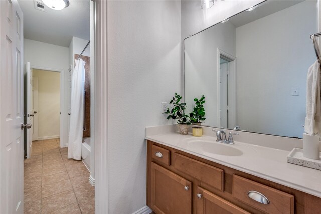 bathroom featuring vanity, tile patterned floors, and shower / bath combo with shower curtain