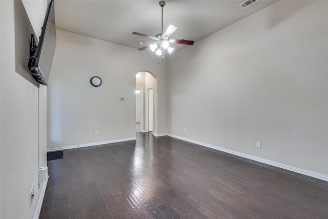 spare room with dark wood-type flooring and ceiling fan