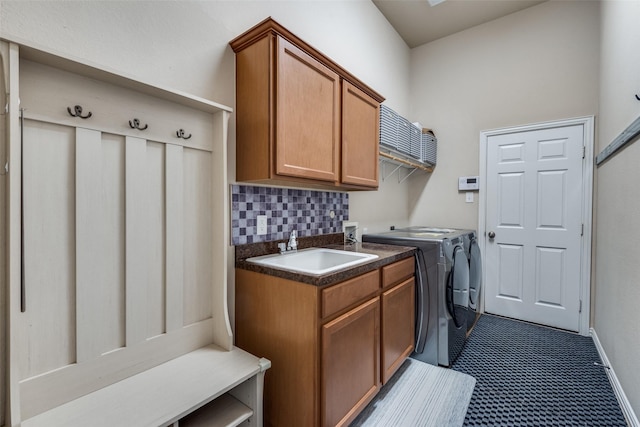 laundry area featuring sink, cabinets, and independent washer and dryer