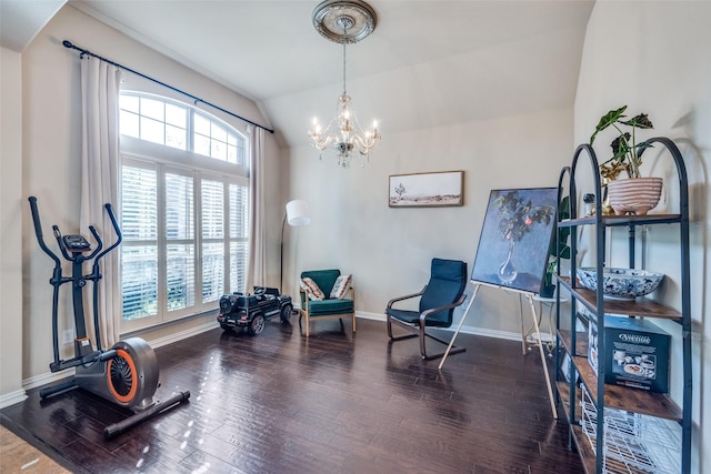 living area featuring dark hardwood / wood-style flooring, vaulted ceiling, and a chandelier