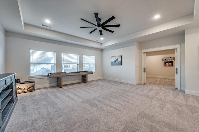 misc room with a tray ceiling, light carpet, ceiling fan, and pool table