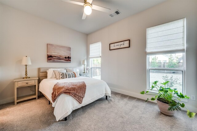 bedroom featuring ceiling fan and carpet