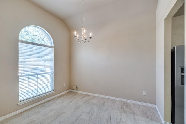 spare room with an inviting chandelier and lofted ceiling