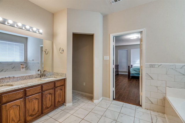 bathroom featuring a tub and vanity