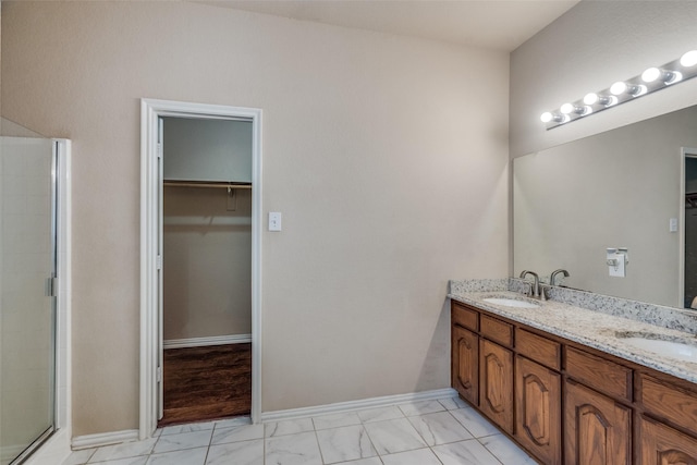 bathroom featuring vanity and an enclosed shower