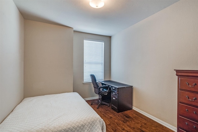 bedroom with dark hardwood / wood-style floors