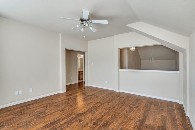 empty room featuring ceiling fan, dark wood-type flooring, and vaulted ceiling