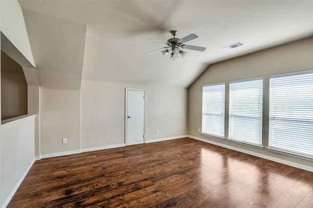 interior space featuring ceiling fan, dark hardwood / wood-style floors, and vaulted ceiling