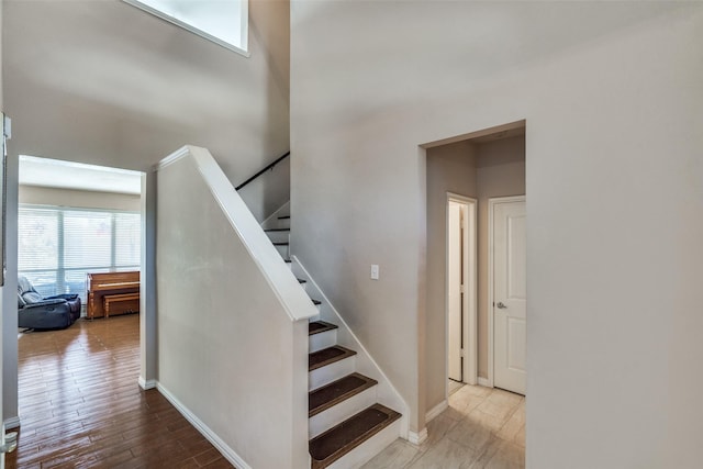 staircase featuring wood-type flooring