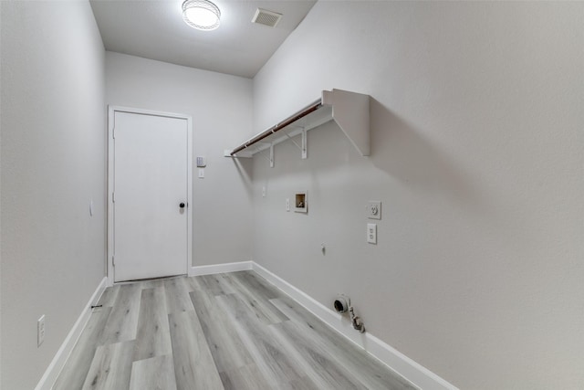 laundry room with hookup for an electric dryer, washer hookup, light hardwood / wood-style floors, and hookup for a gas dryer