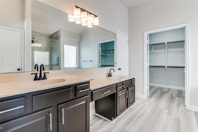 bathroom featuring hardwood / wood-style floors, vanity, and an enclosed shower