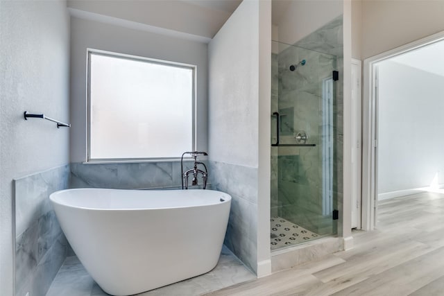 bathroom with wood-type flooring and plus walk in shower