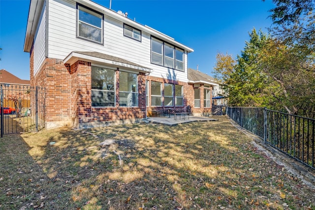 rear view of property with a lawn and a patio area