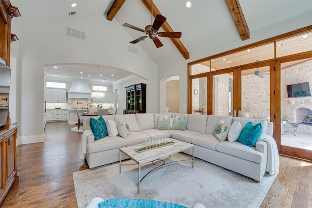 living room featuring ceiling fan, beamed ceiling, high vaulted ceiling, and light wood-type flooring