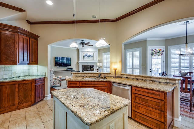 kitchen featuring pendant lighting, dishwasher, sink, and ceiling fan with notable chandelier