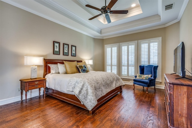 bedroom with dark wood-type flooring, a raised ceiling, ceiling fan, and ornamental molding