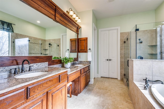 bathroom with vanity and shower with separate bathtub