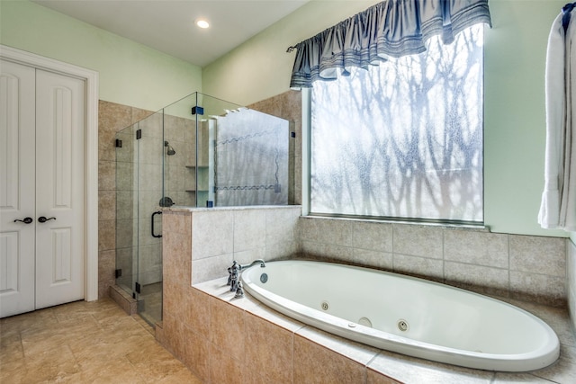 bathroom featuring separate shower and tub