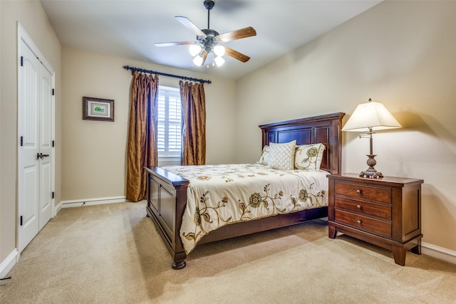 bedroom featuring ceiling fan and light carpet