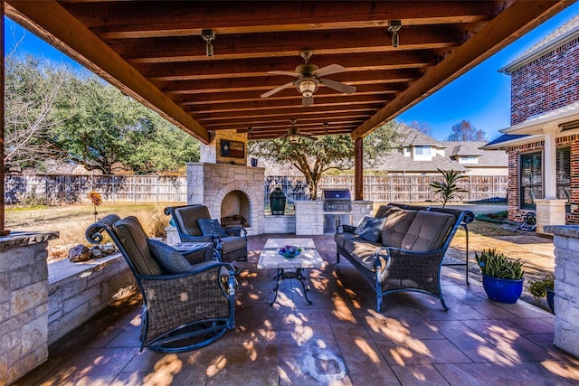 view of patio / terrace featuring an outdoor living space with a fireplace, area for grilling, ceiling fan, and a grill