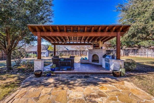 view of patio / terrace with an outdoor kitchen, grilling area, and exterior fireplace