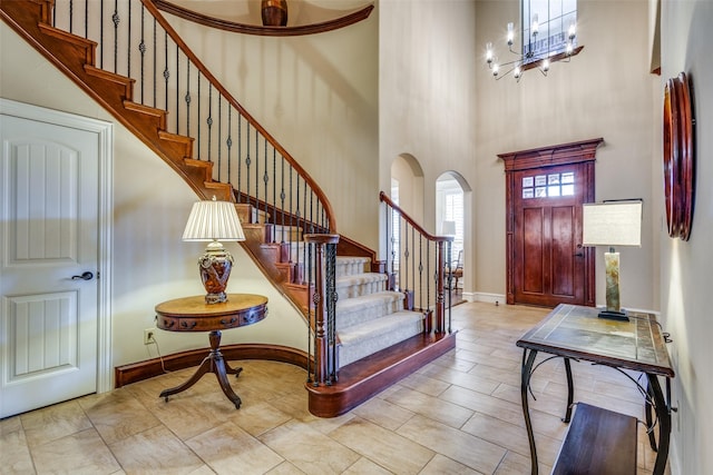 entrance foyer featuring a towering ceiling and a chandelier