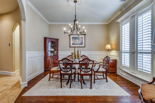 dining space featuring a notable chandelier, crown molding, and a wealth of natural light