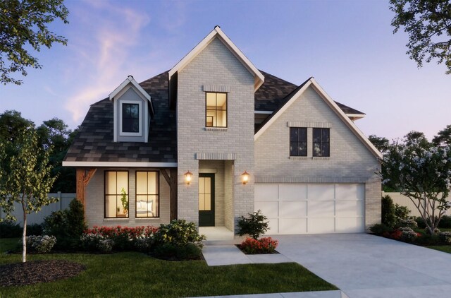 view of front facade with a yard and a garage