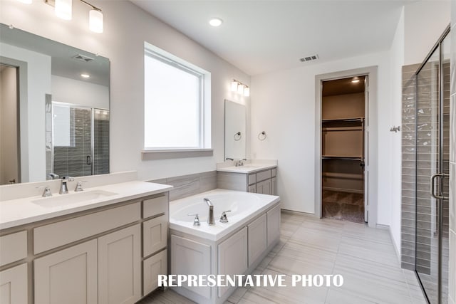 bathroom with vanity, tile patterned flooring, and separate shower and tub