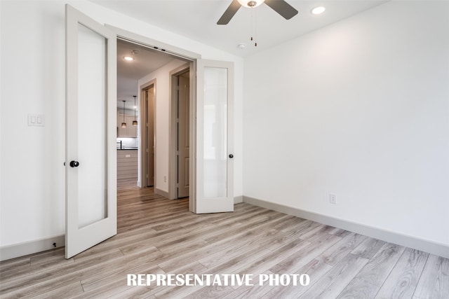 unfurnished bedroom with french doors, ceiling fan, and light wood-type flooring