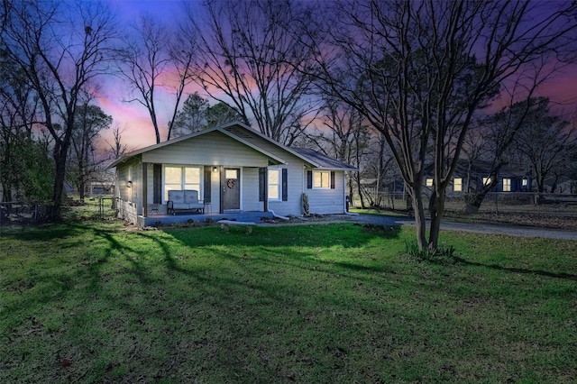 view of front of home with a lawn and covered porch