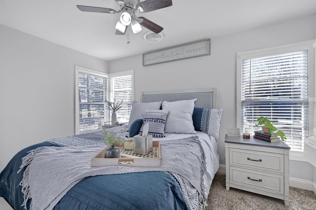 bedroom featuring ceiling fan and light carpet