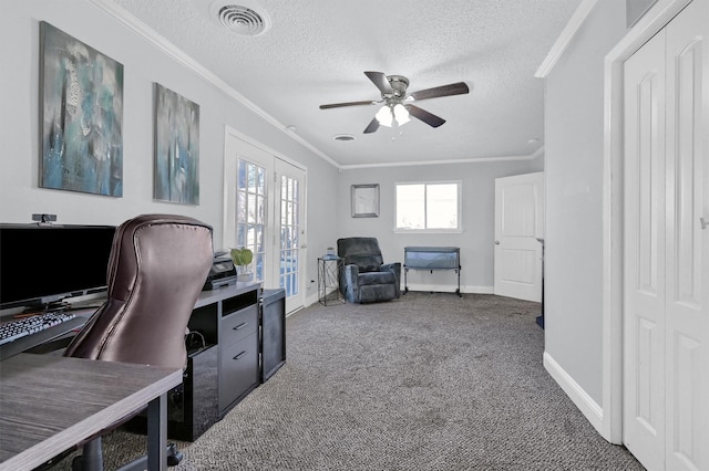 carpeted home office featuring ceiling fan, ornamental molding, a textured ceiling, and french doors