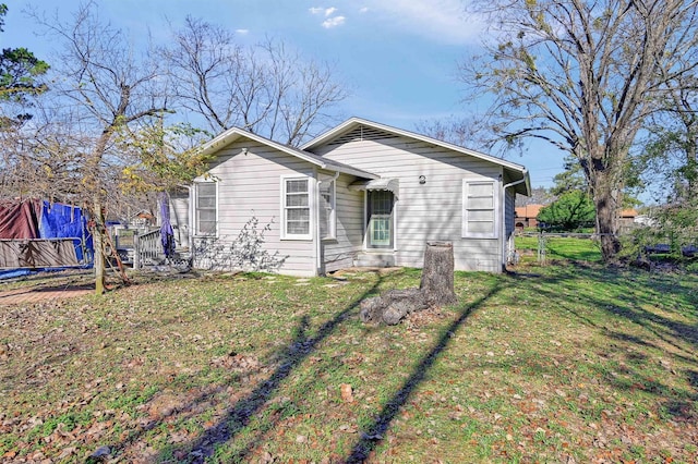 view of front of house featuring a trampoline and a front lawn