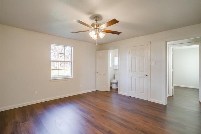 unfurnished bedroom with ensuite bathroom, ceiling fan, and dark hardwood / wood-style floors