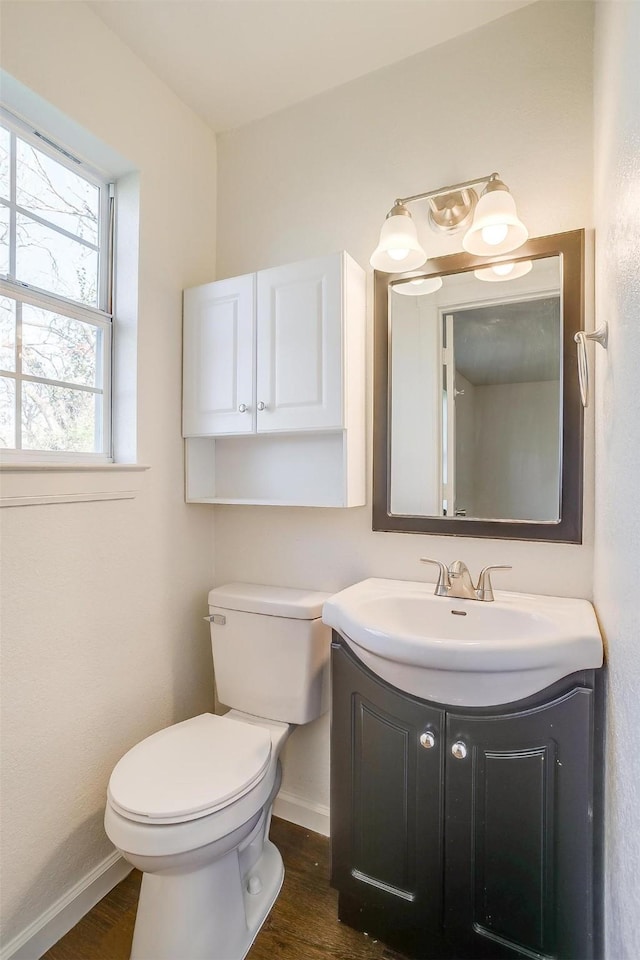 bathroom with vanity, wood-type flooring, and toilet