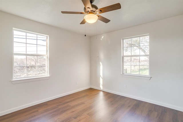 unfurnished room with ceiling fan and dark hardwood / wood-style floors