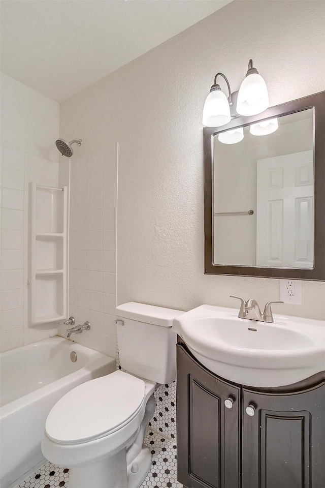 full bathroom with tile patterned floors, vanity, shower / bathtub combination, and toilet