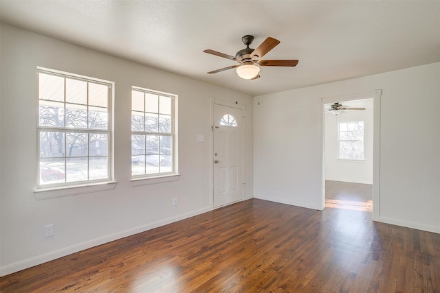 foyer entrance featuring dark wood-type flooring and ceiling fan