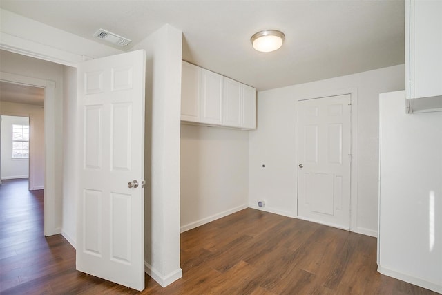 laundry room with cabinets, dark hardwood / wood-style floors, and electric dryer hookup