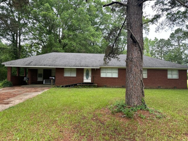 ranch-style house featuring a front yard and a carport