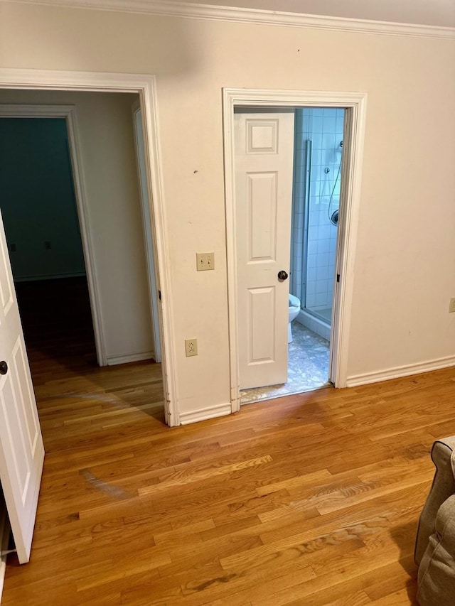 interior space featuring crown molding and light hardwood / wood-style floors