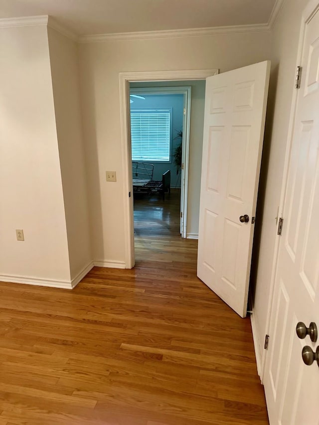 corridor featuring hardwood / wood-style flooring and ornamental molding