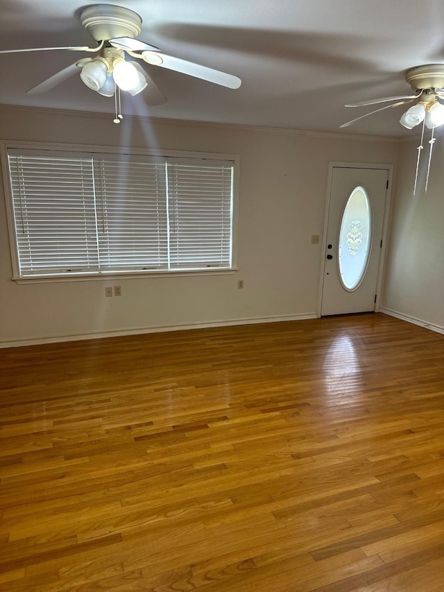 foyer entrance with light hardwood / wood-style floors and ceiling fan