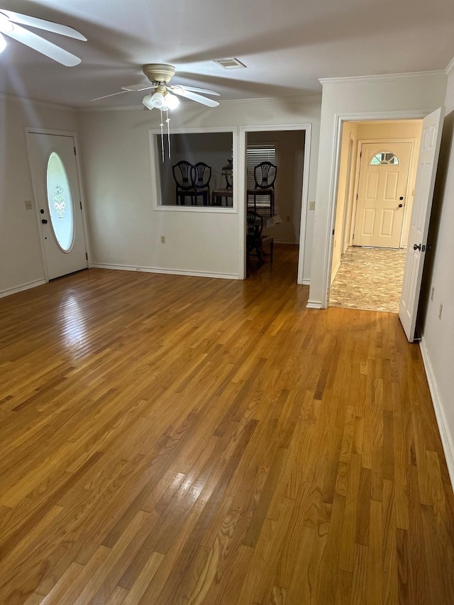 unfurnished living room with crown molding, light hardwood / wood-style flooring, and ceiling fan